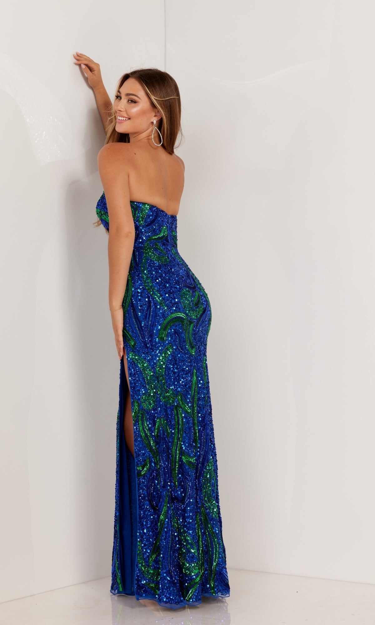 A woman models the Strapless Sequin-Print Long Prom Dress 1105, posing with one arm raised to highlight the gown's side slit and fitted silhouette against a plain white background.